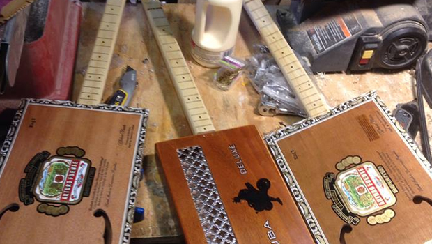 A few different cigar box guitars on Shane Speal's workbench