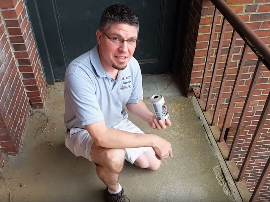 Ben holds a can ready to be prepped using a concrete walkway