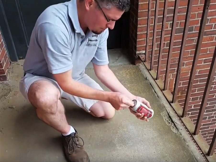 Ben inserts finger into pour-spout and pulls on can-top