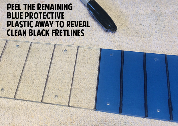 Blue plastic pulled from acrylic fretboard revealing black fret lines