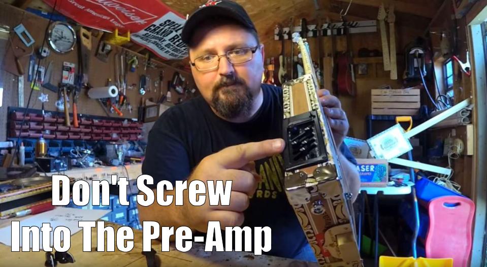 Shane Speal warns to beware of a long box handle screw piercing a cigar box guitar pre-amp