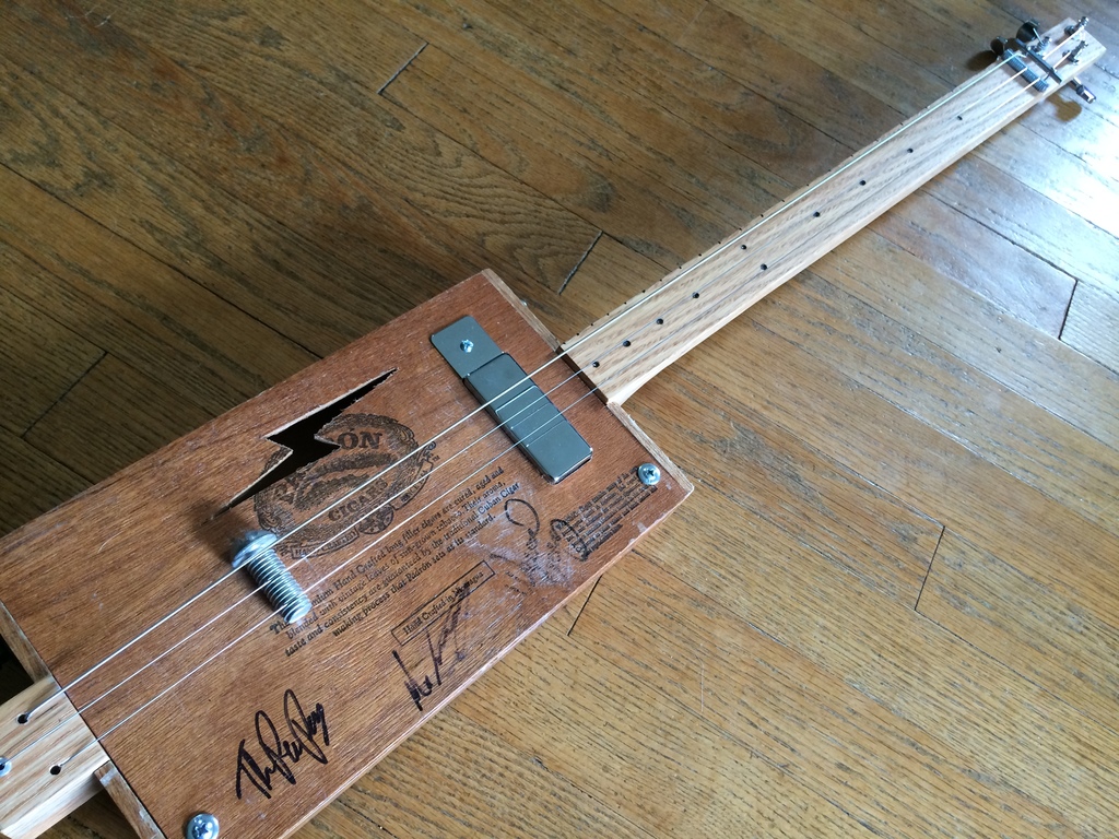 Shane Speal's cigar box guitar with a C. B. Gitty Juke Shack pickup