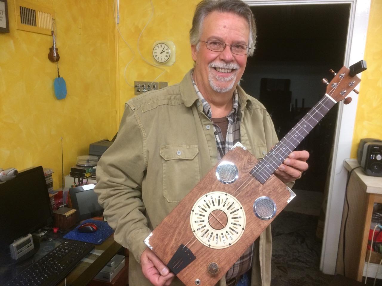 Jackie S. holding his cigar box reso-ukulele