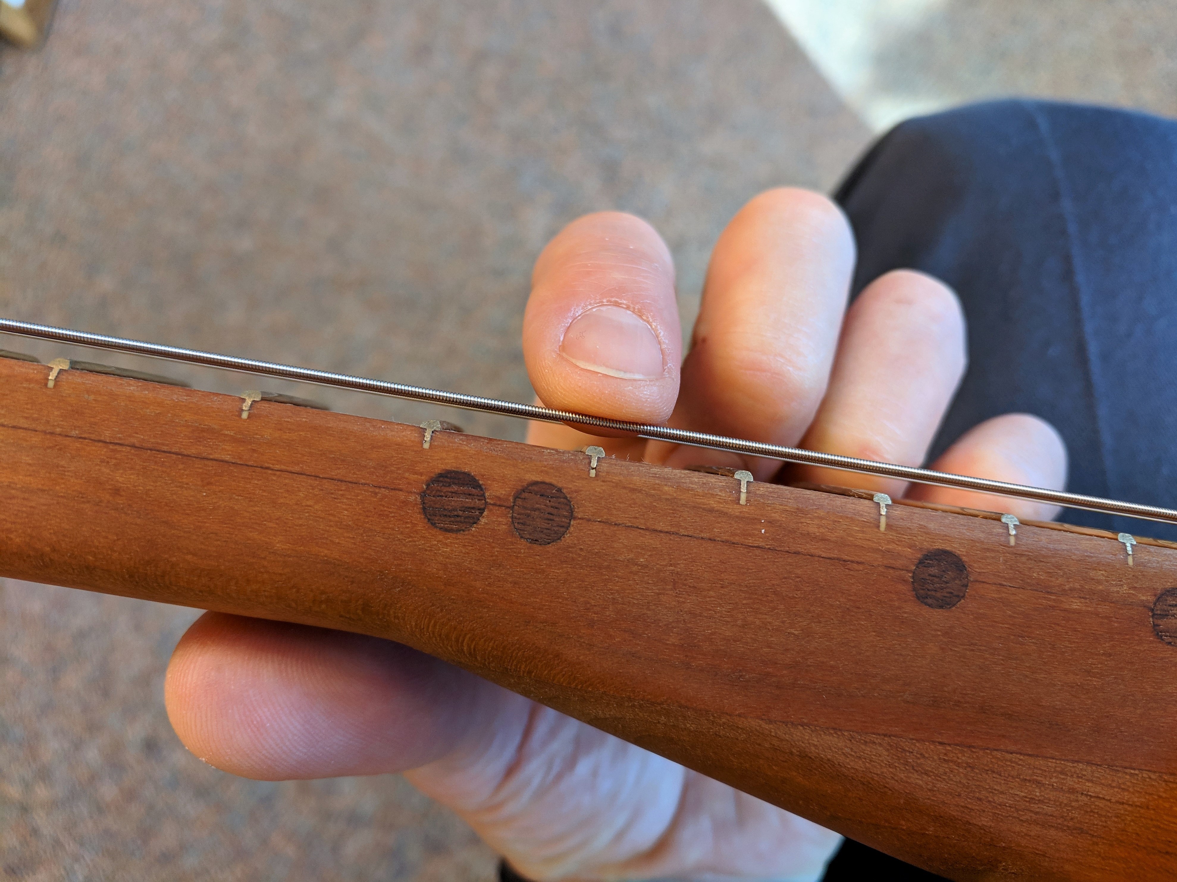 Lightly touching string at the 12th fret