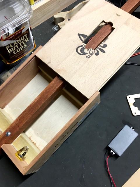 Sliding cigar box lid revealing neck-through construction