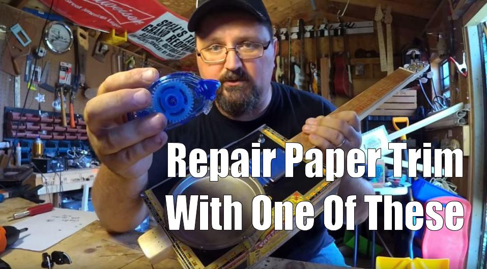 Shane Speal uses a glue roller to repair trim on paper-covered cigar boxes