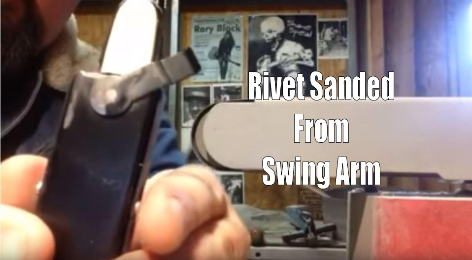 Rivet sanded from swing arm