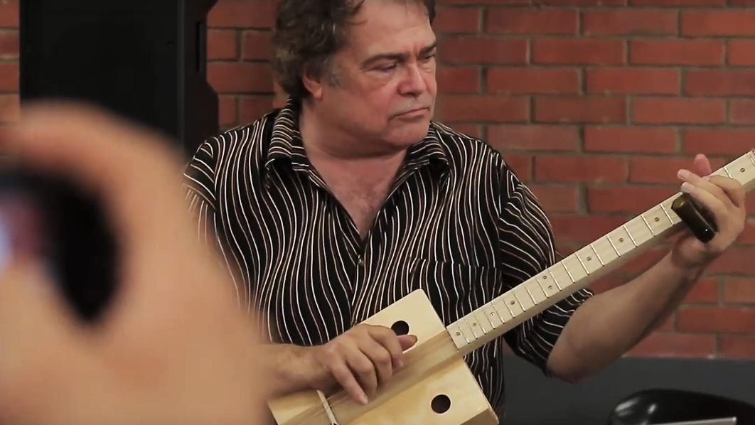 Steve Arvey playing a C. B. Gitty "Big Easy" cigar box guitar in Colombia